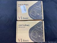 Two boxed Rexing V1 Basic dash cams showing original packaging with printed images and logos.