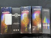 Five boxed karaoke microphones from brands BONNOK, Intelligent Microphone, and FISHOAKY in original packaging.