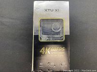 Front of packaging showing XTU X1 branding and 4K 60FPS Dual Color Screen Display text