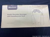 Box showing product name, brand (MaxKare), and model number XKMS-412, with an illustration of the massager.