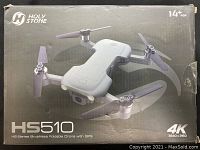 Box of Holy Stone HS510 drone showing front-facing camera on the drone and 4K recording capability in 3840x2160 resolution, suitable for ages 14+.