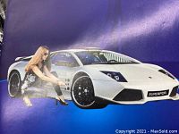 Box cover of the Auto Dent Remover Tool kit showing a woman using the tool on a sports car with the SuperPDR logo on the license plate.