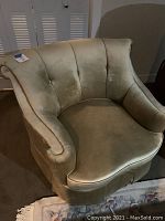 Full view of light green velvet armchair showing shape, color, and condition.