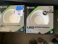 Two boxed Lithonia Lighting LED recessed downlight fixtures, front boxes showing model and specs