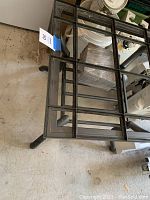 Top view of the wrought iron side table showing the frame designed to hold tile inserts and the square compartments.