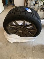 Full view of used tire mounted on alloy rim showing general condition.