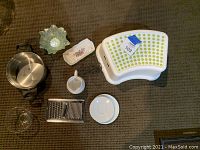 Full lot of kitchen items including step stool, cheese grater, creamer, candle holder, glass dishes, saucers, and mixing bowl.