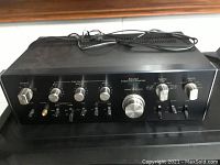 Front full view of Sansui integrated amplifier showing control knobs and top surface