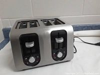 Front view of the 4-slice Black & Decker stainless steel toaster showing the two levers and dials for control.
