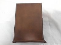 Top view of rectangular brown wooden box with smooth surface.