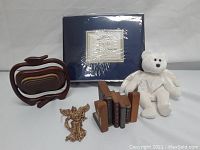 Complete lot with queen size sheet set, stuffed bear, angel ornament, apple-shaped wooden tray, and bookends with mini books.
