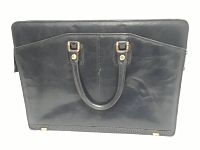 Front view of the black leather briefcase showing the dual handles and front pocket detail.