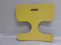 Yellow foam cushion with handle slot and wider top and bottom sections
