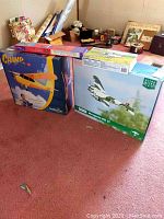 Overview of boxed airplane kits showing HobbyZone Champ, Parkzone Mosquito Mk VI, Revell A-10 Snap-Tite and Skymaster box