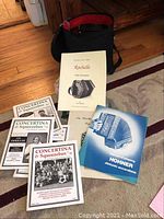 Overview of concertina, tutor and magazines on carpet