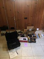 Overall lot view showing Yamaha REX50 in case, microphone stands and other electronics boxed and loose on floor.