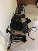 Image showing Boss MA-15A amplifier alongside cases and a green Manfrotto tripod on floor.