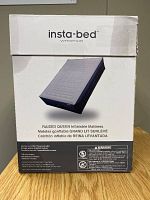 Front of box showing brand Insta-Bed Whispair, product image of the raised queen inflatable mattress, details about internal 4-comfort pump, 3-minute inflation time, multilingual product title.