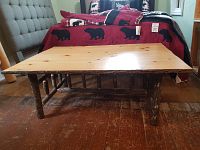 Front view showing tabletop surface and log-style legs