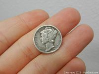 Obverse side of a 1944 Mercury Head dime showing Liberty in profile with winged cap and inscriptions.