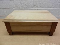 Front view of wooden keepsake box showing wood grain and construction.