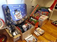 Wide view of Christmas decorations including gift wrap, lighting, and various boxes