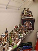 Overall view of multiple ceramic village buildings arranged on a curved base