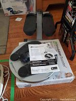 Circulation Booster foot massager unit shown on its original box with user manual on top.