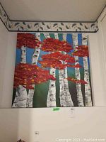 Frontal view of a 36x36 original painting showing birch trees with red and orange leaves against a blue sky and green background.