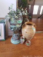Photo showing entire lot of large and small ceramic pots and vases with faux ivy plant in the large green ceramic plant pot