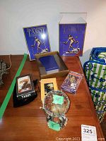 Overall lot view showing three tarot card decks and the glass globe on a wooden table.