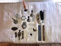Full lot on white cloth showing all vases, votives, candle holders, and figurines in a flat lay