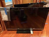 Front view of Sony flat screen TV with black bezel and stand.