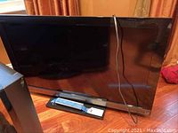 Front and side view of Sony Bravia KDL-40EX400 39-inch LCD TV showing its screen and attached power cable.