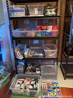 Shelf with containers holding gimp trim, glass blocks, duct tape and various hardware