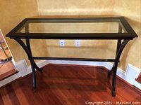 Full front view of the glass top sofa table showing rectangular shape and metal frame.