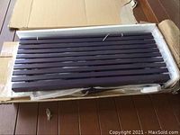 Boxed slatted wooden panel component in original styrofoam packaging