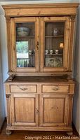 Frontal view of the two-piece antique pine wood hutch showing upper glass doors, drawers and lower wood doors