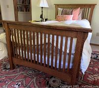 Assembled twin bed frame showing headboard, footboard, slatted design and overall condition