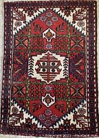 Full view of runner laid flat, showing entire red field, central ivory medallion, and patterned borders