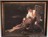 Framed Caravaggio canvas print showing Francis of Assisi and an angel, dark background, detailed depiction