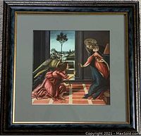 Square framed print of Botticelli's Annunciation showing the angel Gabriel and Mary indoors, with a detailed Renaissance background and checked floor pattern.