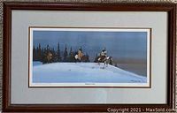 Framed print 'Returning to Camp' by G. Running Wolf, showing figures on horseback in snowy landscape with pine trees, wood frame and glass cover.