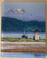 Glass cutting board with painted scenic view of Gig Harbor and Mt. Rainier with lighthouse and sailboat.