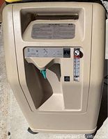 Front view showing control panel, analog flow meter, oxygen outlet, and OSD indicator