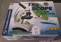 Closed product box showing the Thames & Kosmos TK2 Scope brand, features, and kit contents