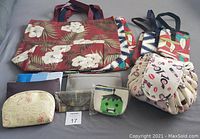 Various pouches including small makeup/accessory pouches, Marvel Hulk coin pouch, handmade credit card wallet, and a round large travel makeup pouch with cherry and heart design, alongside the large beach totes.