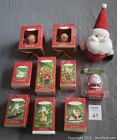 All ornaments and figures arranged together, mostly in original boxes, showing labels and packagings