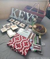 Shows full lot of living room décor items including basket, key holder, framed art, blackout curtains, candles, and decorative bowls.
