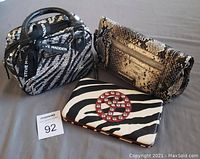 Photo showing all three items: Steve Madden mini carry-on bag with sequin zebra print, Kenneth Cole snake print wristlet bag, and zebra pattern wallet with peace sign.
